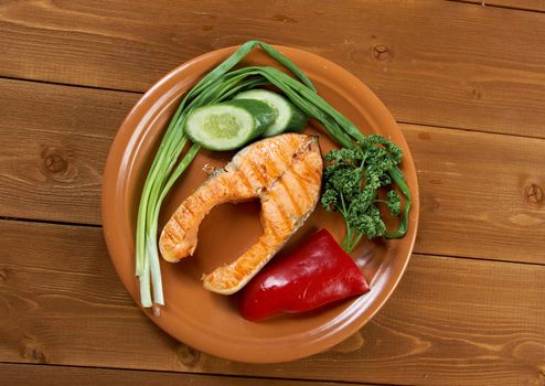 delicious grilled salmon steak with vegetables .closeup