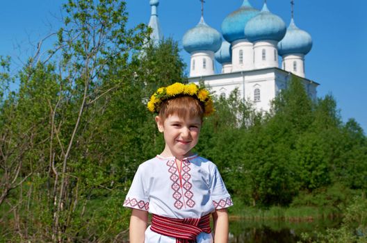 Russian little boy  on a orthodox church background.