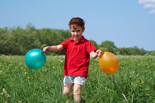 small boy with colorful  air balloon outdoor