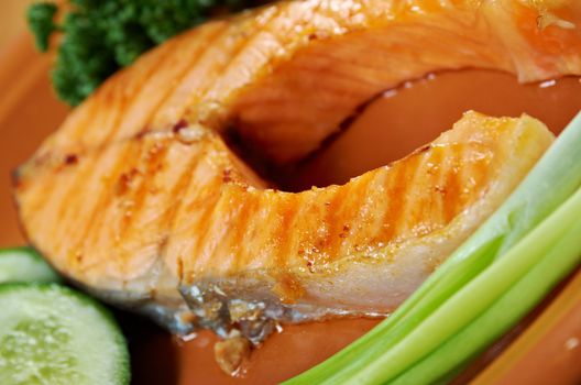 delicious grilled salmon steak with vegetables . Shallow depth-of-field