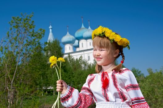 Russian little girl  on a orthodox church background.