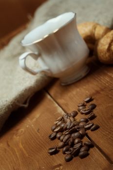 Coffee cup with cinnamon and coffee beans background