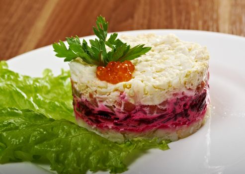 Salad with salmon with sauce and small cake.closeup