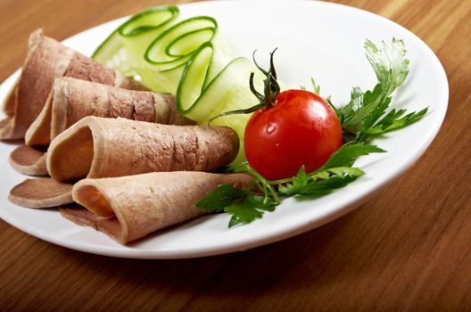 Sliced beef tongue with horseradish and vegetable