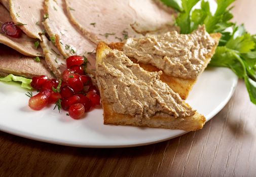 Beautiful slice meatarrangement with some vegetables. Shallow depth-of-field.  