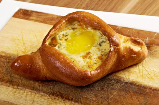 Adjaruli khachapuri, filled with cheese and topped .traditional dish of georgian cuisine