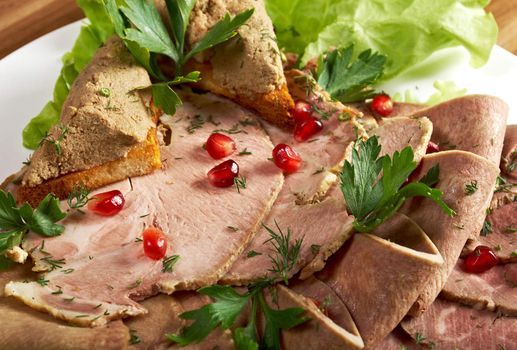 Beautiful slice meatarrangement with some vegetables. Shallow depth-of-field.  