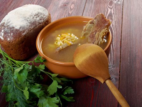 Pea soup with beef ribs  and farmhouse bread,edible greens .farmhouse kitchen