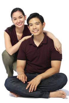 A young attractive couple smiling at the camera