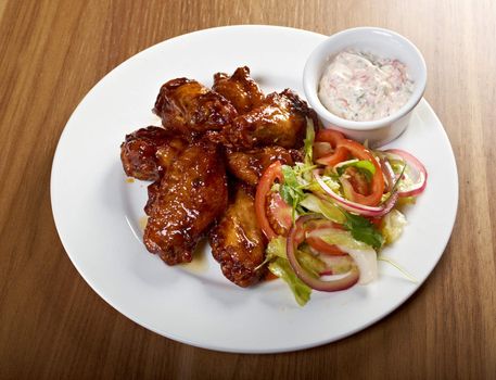 Roasted chicken wings on plate.Shallow depth-of-field. 