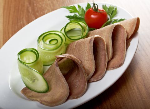 Sliced beef tongue with horseradish and vegetable