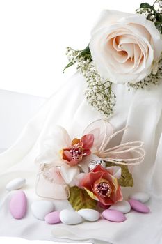 Wedding favors,wedding rings and flowers on white background