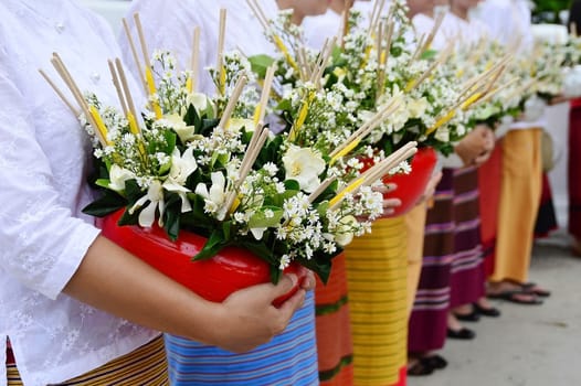 flowers in tray on women hand for buddhist sacrifice, from Intakin Festival, Chiangmai Thailand