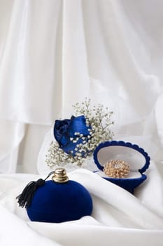 a  blue roses and wedding rings on white background