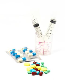 Medicine pills and tablet with syringe in the bottles