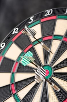 Colorful darts hit dartboard