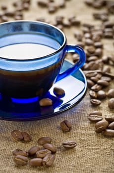 coffee beans with cup on saucer