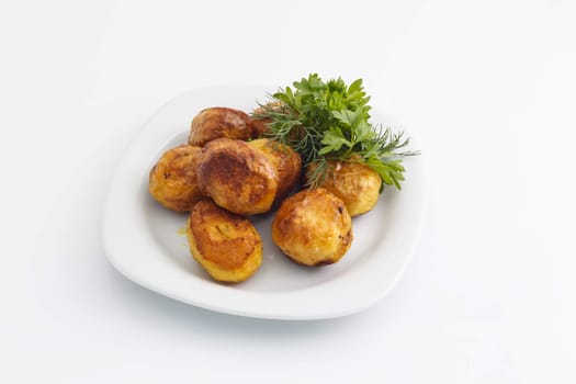 Baked potatoes with dill and parsley on a white background