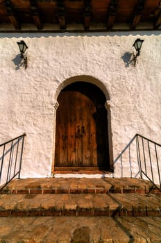 Old wooden door with white colonial wall