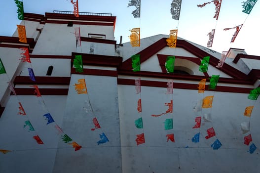 View of white church with waving flags