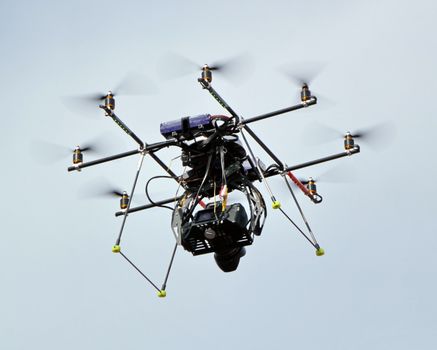 An octocopter with camera flying in the air