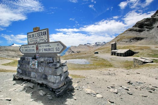 Signs and church at the top of Iseran pass by summer day, France