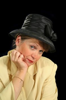 Middle aged female with an inquiring look in a black hat.