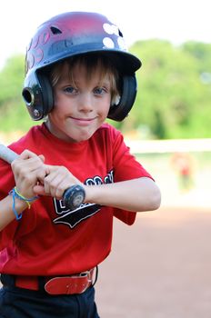 Happy and smiling LIttle league baseball player up close.