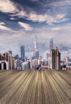 Cityscape of Hong Kong skyscrapers and skyline with wooden ground.
