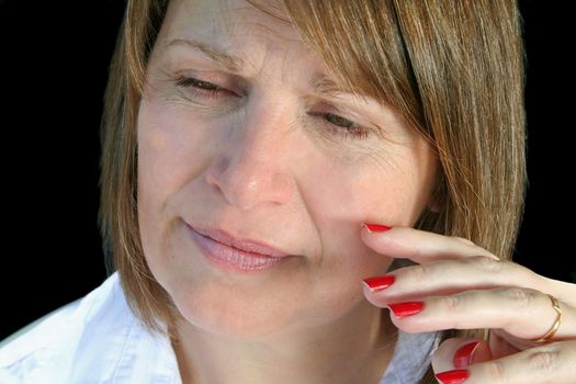 Thoughtful middle aged woman with a natural look.