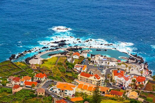 View of the village of Porto Moniz with lava-rock pool, Madeira Island, Portugal