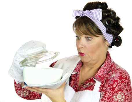 Frumpy housewife gets a surprise looking in the baking dish.