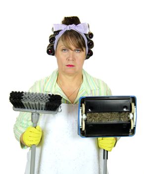 Unhappy and apathetic frumpy housewife standing with broom and carpet sweeper.
