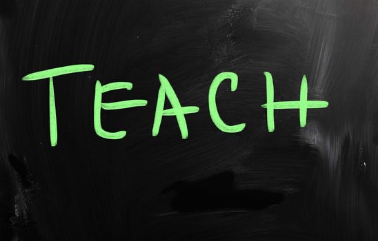 "Teach" handwritten with white chalk on a blackboard