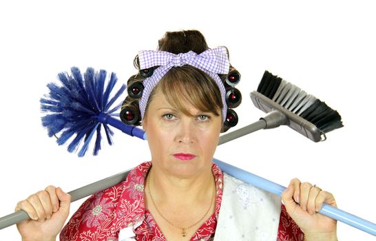 Bored frumpy housewife with carpet sweeper and broom over her shoulders.