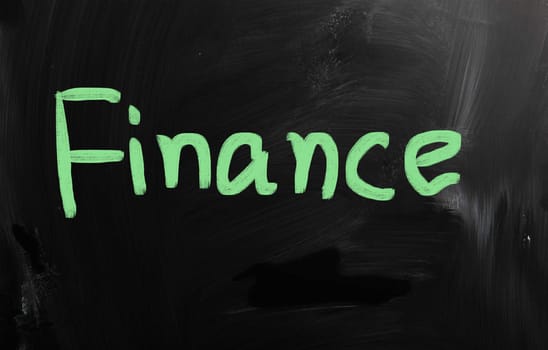 "Finance" handwritten with white chalk on a blackboard