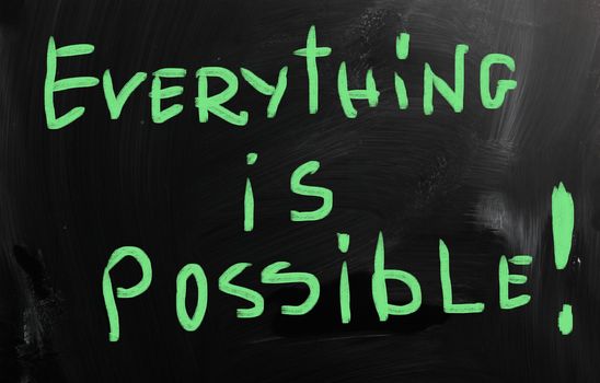 "Everything is possible" handwritten with white chalk on a blackboard