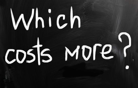 "Which costs more?" handwritten with white chalk on a blackboard