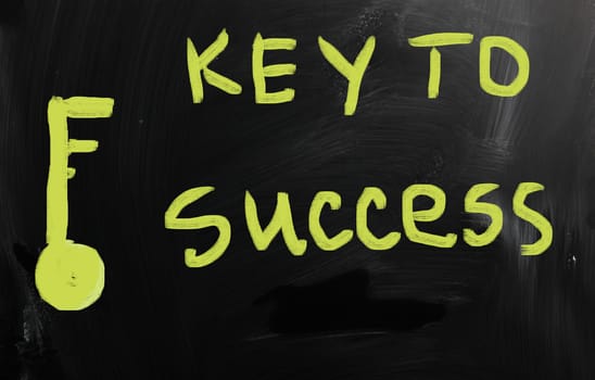 "Key to success" handwritten with white chalk on a blackboard