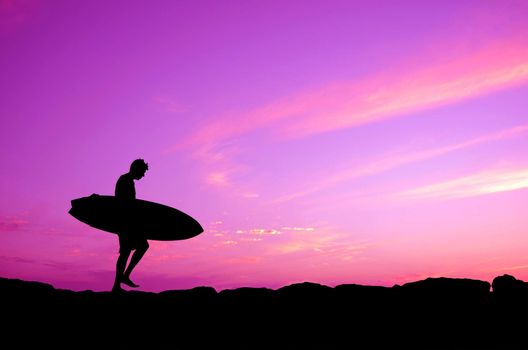 Vacation Silhouette Of A Surfer Carrying His Board Against A Purple Sunset