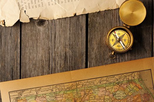 Antique brass compass over old map