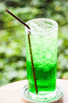 Fresh sweet green drink with ice cubes