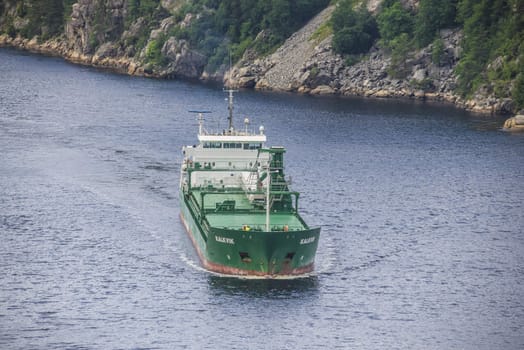 Cargo ship Kalkvik  going to the port of Halden, Norway in order to unload clay. The picture is shot from Svinesund Bridge.