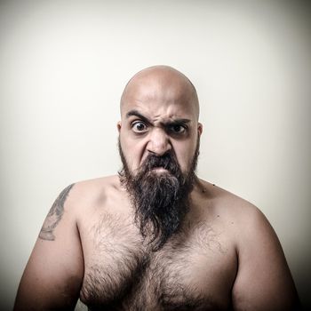 super power angry muscle bearded man  on gray background