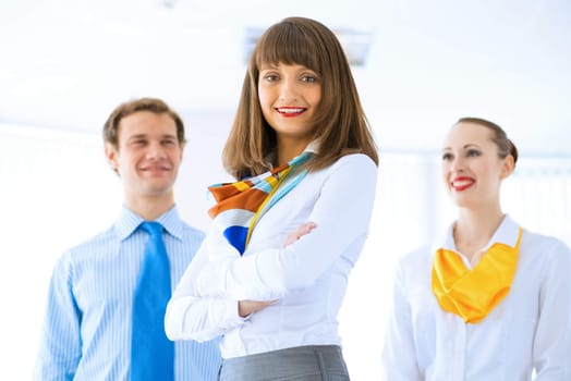 Portrait of a young successful business woman standing against colleagues