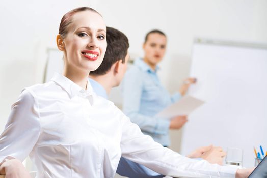 business woman doing a report next presentation boards, listening to her colleagues