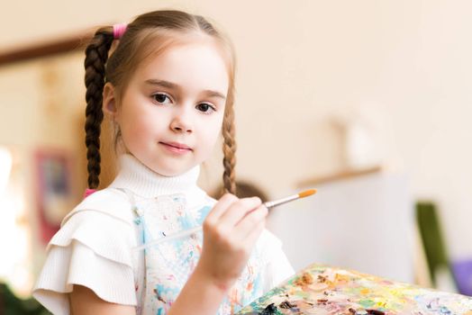 portrait of a girl standing next to his easel, a drawing lesson