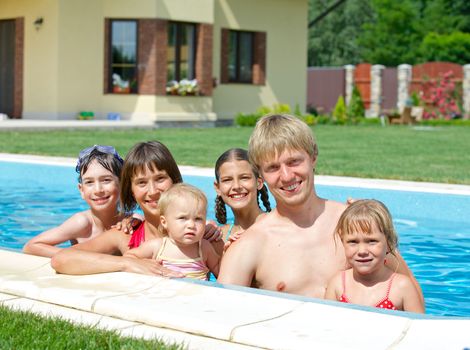 Summer vacation. Happy family with four kids in swimming pool outdoors