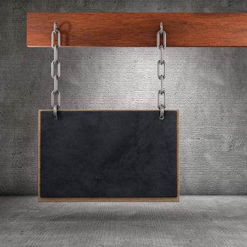 Blackboard fixed with chains on wood surface