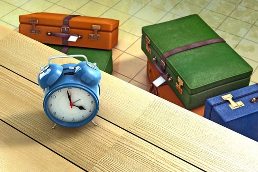 Alarm clock on a table with suitcases as background